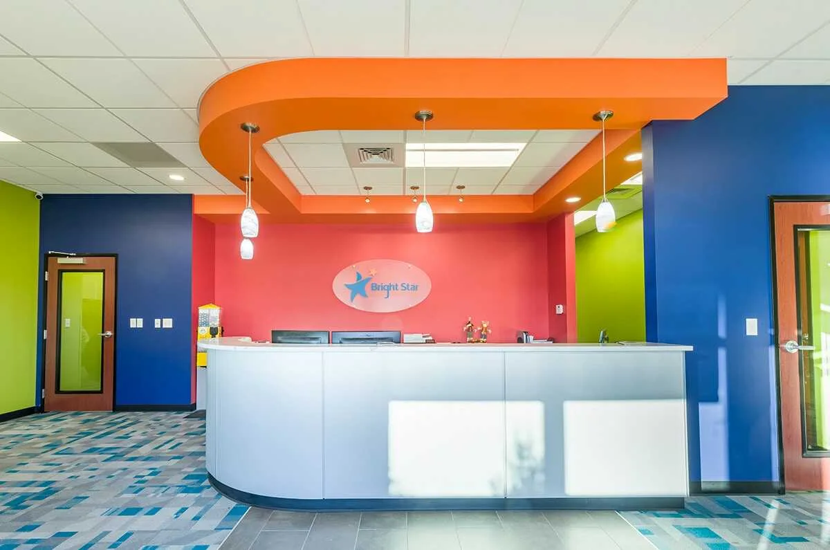 Bright Star Kids Dentistry reception desk with a colorful space-themed lobby