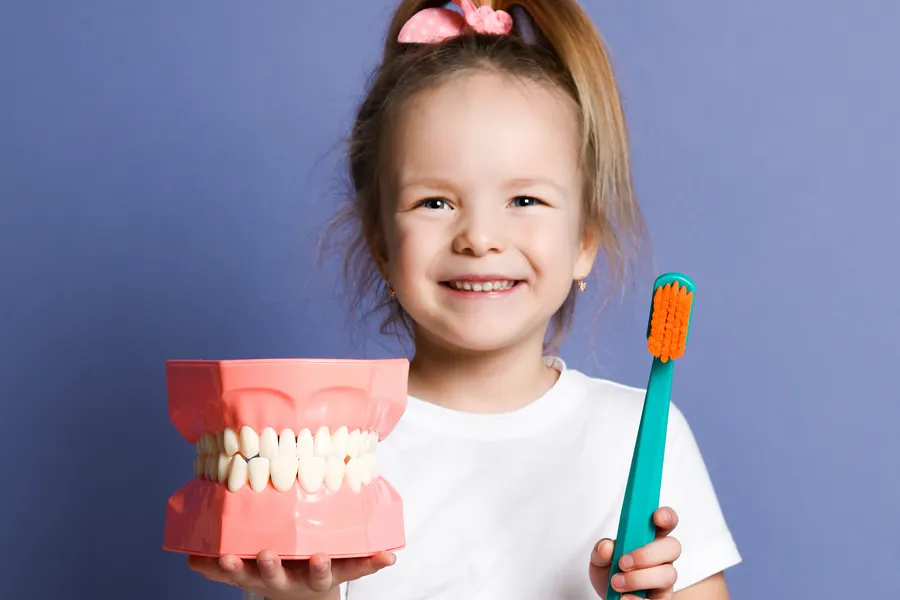 Child learning to brush teeth independently